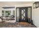 Inviting front entry featuring a unique steel door with sidelights and a cozy seating area at 19 E Boca Raton Rd, Phoenix, AZ 85022