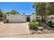 Charming single-story home with a two-car garage, desert landscaping, and secure gated front entry at 19 E Boca Raton Rd, Phoenix, AZ 85022