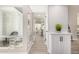Bright hallway with white cabinets, wood-look tile flooring, and a view of the outdoor seating area at 19 E Boca Raton Rd, Phoenix, AZ 85022