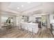 Spacious kitchen with white cabinets, stainless steel appliances, breakfast bar, and wood-look tile flooring at 19 E Boca Raton Rd, Phoenix, AZ 85022
