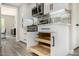 View of kitchen showing pull-out shelves, white cabinets, stainless steel appliances, and modern design at 19 E Boca Raton Rd, Phoenix, AZ 85022