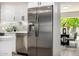 Updated kitchen with stainless steel appliances, subway tile backsplash, and access to the dining area at 19 E Boca Raton Rd, Phoenix, AZ 85022