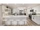 Updated kitchen boasts white cabinets, stainless steel appliances, breakfast bar, and stylish tile backsplash at 19 E Boca Raton Rd, Phoenix, AZ 85022