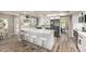 Modern kitchen featuring white cabinets, stainless steel appliances, large breakfast bar with seating for three at 19 E Boca Raton Rd, Phoenix, AZ 85022