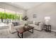Comfortable living room with a neutral color palette, stylish rug, and lots of natural light at 19 E Boca Raton Rd, Phoenix, AZ 85022