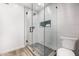 Modern walk-in shower featuring white tile, a rainfall showerhead, and a built-in niche at 19 E Boca Raton Rd, Phoenix, AZ 85022