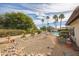 Backyard featuring desert landscaping and a pool, offering low-maintenance elegance and relaxation at 1908 E Beck Ln, Phoenix, AZ 85022