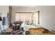 Bright bathroom with a soaking tub, gold decor, and natural light from the window at 1908 E Beck Ln, Phoenix, AZ 85022