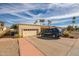 Spacious home exterior with large driveway and lush palm trees at 1908 E Beck Ln, Phoenix, AZ 85022