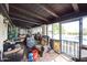 Enclosed patio with comfortable seating, ceiling fan, and views of the pool area at 1908 E Beck Ln, Phoenix, AZ 85022