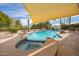 Pool featuring a sun shade and spa, surrounded by desert landscaping creating an inviting outdoor oasis at 1908 E Beck Ln, Phoenix, AZ 85022