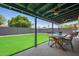 Covered patio and artificial grass for low maintenance in this landscaped backyard at 1937 E Loyola Dr, Tempe, AZ 85282