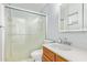 Clean bathroom features a glass shower, wood vanity, and white fixtures at 1937 E Loyola Dr, Tempe, AZ 85282