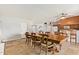Open dining area with a large wood table, tile floors, access to other rooms, and backyard views at 1937 E Loyola Dr, Tempe, AZ 85282