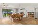 Spacious dining area with backyard access, large table, brick fireplace, and tile flooring at 1937 E Loyola Dr, Tempe, AZ 85282