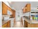 Efficient kitchen with tile floors, breakfast bar, and abundant natural light from the backyard door at 1937 E Loyola Dr, Tempe, AZ 85282