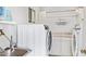 Convenient laundry room with a sink, modern washer, and dryer at 1937 E Loyola Dr, Tempe, AZ 85282