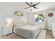Comfortable main bedroom featuring a ceiling fan, a big window, and neutral decor at 1937 E Loyola Dr, Tempe, AZ 85282