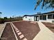 Spacious backyard with minimal landscaping, concrete walkway, and white exterior walls at 1941 E Ellis Dr, Tempe, AZ 85282