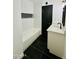 Renovated bathroom with a new vanity, black fixtures, white subway tile and dark tile flooring at 1941 E Ellis Dr, Tempe, AZ 85282