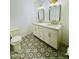 Well-lit bathroom featuring a dual sink vanity, modern fixtures, and decorative tile flooring at 1941 E Ellis Dr, Tempe, AZ 85282