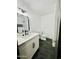 Well-lit bathroom featuring a modern vanity, dark fixtures, white subway tile and dark tile flooring at 1941 E Ellis Dr, Tempe, AZ 85282
