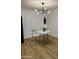Dining area with a marble table, modern lighting, and white plantation shutters at 1941 E Ellis Dr, Tempe, AZ 85282