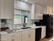 Updated kitchen with white cabinets, gold hardware, granite countertops, and stainless steel appliances at 1941 E Ellis Dr, Tempe, AZ 85282