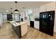 Open kitchen showcasing a center island, modern appliances, white cabinetry, and access to the dining room at 1941 E Ellis Dr, Tempe, AZ 85282