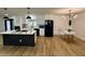 Modern kitchen with white cabinetry, stainless steel appliances, and a large island with breakfast bar at 1941 E Ellis Dr, Tempe, AZ 85282