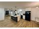 Spacious kitchen features white cabinets, black appliances, a center island, and hardwood flooring at 1941 E Ellis Dr, Tempe, AZ 85282
