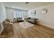 Bright living room with modern decor, wood floors, neutral paint and large window with shutter style blinds at 1941 E Ellis Dr, Tempe, AZ 85282
