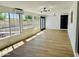 Sun room featuring wood floors, neutral paint, modern lighting, and large windows providing lots of natural light at 1941 E Ellis Dr, Tempe, AZ 85282