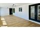 Bright sun room featuring neutral paint, wood floors, modern lighting, and ample natural light at 1941 E Ellis Dr, Tempe, AZ 85282