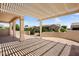Spacious back patio with pergola offering shade, overlooking the green landscaping at 20007 N Siesta Rock Dr, Surprise, AZ 85374