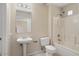 Functional bathroom with single sink vanity, toilet, and shower-tub combo with a window at 20007 N Siesta Rock Dr, Surprise, AZ 85374