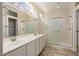 Bathroom featuring a double sink vanity, shower with glass doors, and contemporary fixtures at 20007 N Siesta Rock Dr, Surprise, AZ 85374