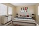 Staged bedroom with neutral paint, stylish decor, and natural light from large windows at 20007 N Siesta Rock Dr, Surprise, AZ 85374