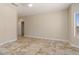 Spacious bedroom with neutral walls, tiled floors, ceiling fan, walk in closet and window at 20007 N Siesta Rock Dr, Surprise, AZ 85374