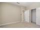 Neutral bedroom featuring carpet flooring, closet, entry door and ceiling fan at 20007 N Siesta Rock Dr, Surprise, AZ 85374