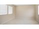 Bright, empty room featuring tile flooring, neutral walls, and natural light from multiple windows at 20007 N Siesta Rock Dr, Surprise, AZ 85374