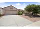 Charming single-story home with desert landscaping, a two car garage and a neutral color palette at 20007 N Siesta Rock Dr, Surprise, AZ 85374