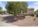 Beautiful home featuring desert landscaping, mature tree and neutral color scheme at 20007 N Siesta Rock Dr, Surprise, AZ 85374