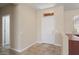 Bright entryway featuring tiled floors, white door, and neutral wall color at 20007 N Siesta Rock Dr, Surprise, AZ 85374