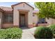 Inviting front entrance with desert landscaping, covered porch, and tiled roof at 20007 N Siesta Rock Dr, Surprise, AZ 85374