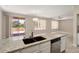 Bright kitchen with granite countertops, stainless steel appliances, and living room views at 20007 N Siesta Rock Dr, Surprise, AZ 85374