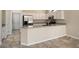 An updated kitchen featuring stainless steel appliances, granite countertops, and white cabinets at 20007 N Siesta Rock Dr, Surprise, AZ 85374