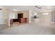 Open floor plan featuring carpet and tile flooring, white kitchen and neutral walls at 20007 N Siesta Rock Dr, Surprise, AZ 85374