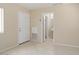 Neutral living space with an exterior door, bathroom access, and tile flooring at 20007 N Siesta Rock Dr, Surprise, AZ 85374