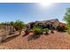 Spacious backyard showcasing desert landscaping, a covered patio, and a private pool at 20223 N Sundance Way, Surprise, AZ 85374